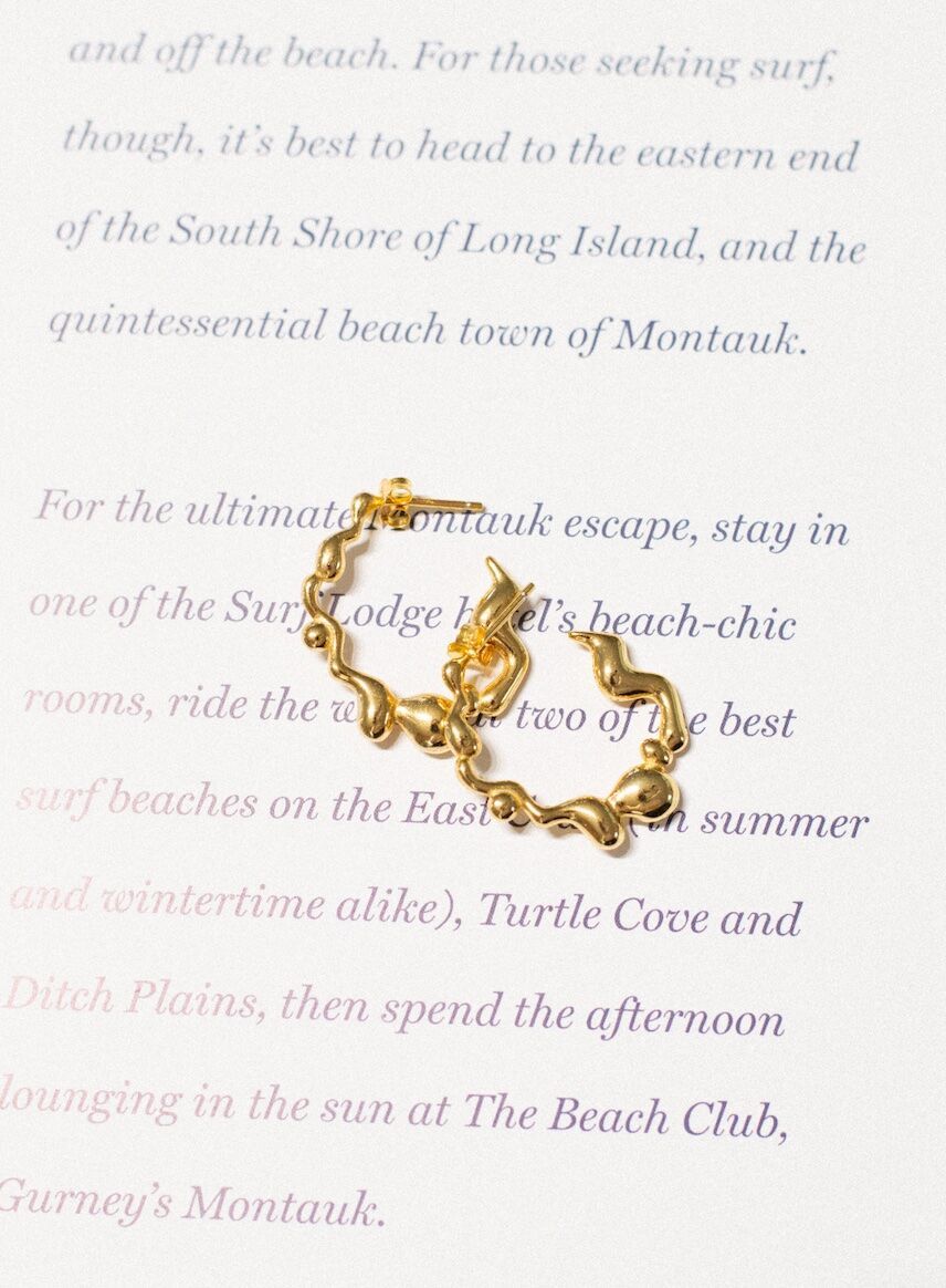 Gold hoops styled on a magazine page