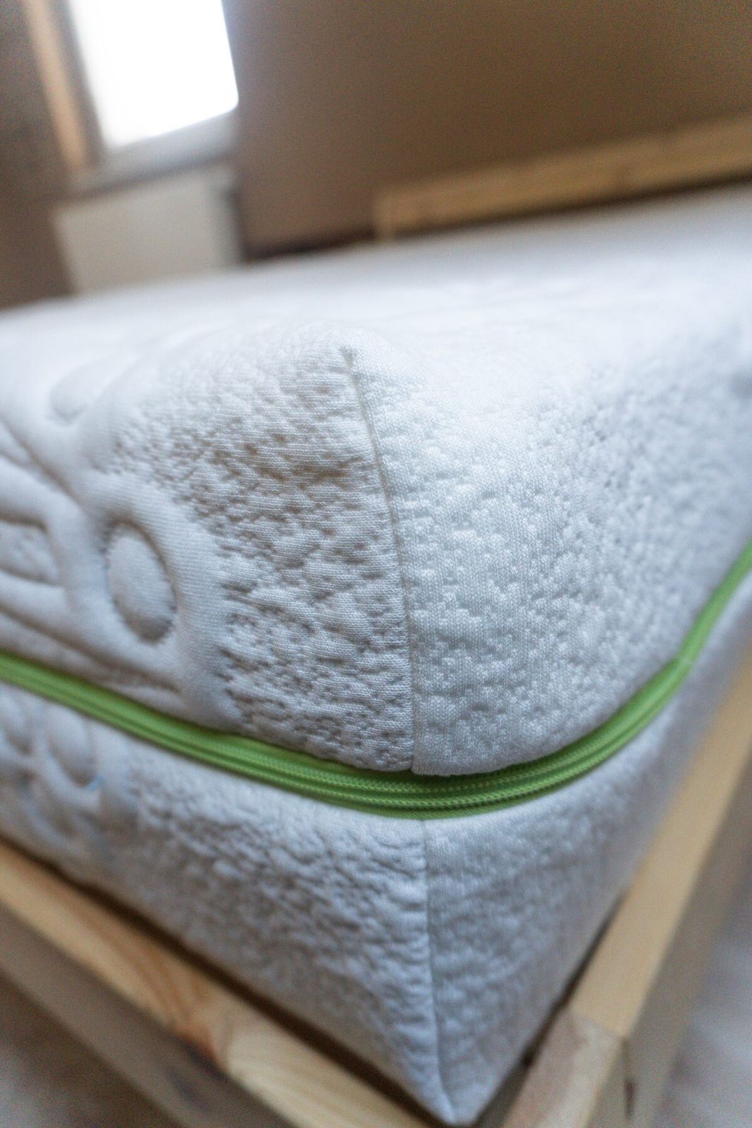Close-up of mattress corner with green zipper